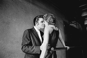 This June 30, 1956 photo provided by courtesy of Taschen shows, 'The Kiss,' at the Mosque Theater in Richmond, Va. The image is Wertheimer's most iconic photograph, and the identity of the woman was unknown until she came forward in 2011. The photograph is included in the book, 'Elvis and the Birth of Rock and Roll, ' by author/photographer, Alfred Wertheimer, published by Taschen. Wertheimer, the photographer whose portraits of Presley documented the birth of a music legend, has died. He was 85. (AP Photo/Courtesy Taschen, Copyright Alfred Wertheimer)