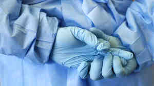 The gloved hands of an army nurse are seen during a demonstration of an isolation chamber for the treatment of infectious disease patients, at the Germany army medical centre, Bundeswehr Clinc, in Koblenz on Oct. 16, 2014.