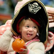 Candice Nelson fits her daughter Arya Kubesh with a Halloween hat at a store at Galleria Mall in Edina, Minn. Retailers are hoping Halloween will give them a good bounce into the peak spending time of the year.