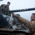Brad Pitt (foreground) instructs Logan Lerman about operating the tank called Fury.
