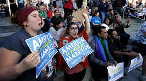 People hold signs, including some reading "America is ready for marriage," at a same-sex marriage victory celebration on Oct. 6 in Salt Lake City, Utah. America may be ready, but Republicans aren't: Rising popular support for same-sex marriage is posing a problem for the GOP.