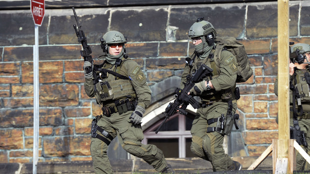 A Royal Canadian Mounted Police intervention team responds to a reported shooting at Parliament building in Ottawa on Oct. 22, 2014.