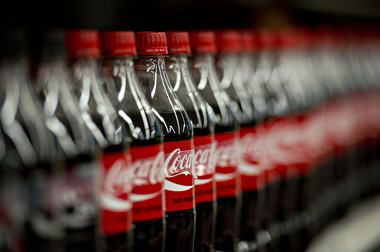 Coca-Cola Co. and International Business Machines Corp. got a stark message from investors this week: If they can’t keep their businesses in growth mode, they’d better do something about it -- and fast.