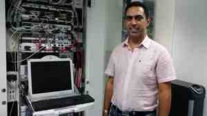 Ramzi El-Fekih, CEO of Creova, stands in his server room in Tunis. He has built a mobile payments company, but because of banking restrictions, Tunisians can use his product only for domestic purchases.