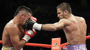 Rocky Juarez of the U.S. gets punched in the face in July 2010 by Jorge Linares of Venezuela during their WBA Fedelatin lightweight title fight in Las Vegas. Some researchers believe the human face evolved to take punches — without, of course, the boxing gloves.