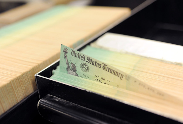 U.S. Treasury checks are piled at the U.S. Treasury printing facility July 18, 2011 in Philadelphia, Pennsylvania. (Photo illustration by William Thomas Cain/Getty Images)