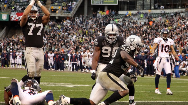 OAKLAND, CA - DECEMBER 19:  Quentin Groves #52 of the Oakland Raiders celebrates with Kamerion Wimbley #96 and Matt Shaughnessy #77 after he stopped Correll Buckhalter #28 of the Denver Broncos for a safety at Oakland-Alameda County Coliseum on December 19, 2010 in Oakland, California.  (Photo by Ezra Shaw/Getty Images)