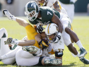 EAST LANSING, MI - SEPTEMBER 27:  Dominic Rufran #33 of the Wyoming Cowboys is tackled by Chris Frey #23 of the Michigan State Spartans, bottom, and safety Demetrious Cox #7 during the third quarter at Spartan Stadium on September 27, 2014, in East Lansing, Michigan. The Spartans defeated the Cowboys 56-14. (Photo by Duane Burleson/Getty Images)