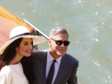 Although unclear whether the dress pictured here is an Oscar de la Renta design, Amal Alamuddin is the latest public figure to have worn a design by the fashion icon when she married George Clooney. Alamuddin is pictured here on a taxi boat on Sept. 29, 2014 in Venice, after a civil ceremony. (credit: PIERRE TEYSSOT/AFP/Getty Images)