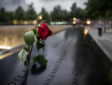 A wilting rose is left in remembrance of those lost before the memorial observances held at the site of the World Trade Center in on September 11, 2014. (Photo by Andrew Burton /Getty Images)