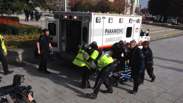 Police and paramedics transport a wounded Canadian soldier on October 22, 2014 in Ottawa, Ontario. (credit: MICHEL COMTE/AFP/Getty Images)