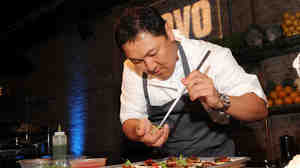 Chef Sang Yoon prepares a dish at the Top Chef Masters Season 5 Premiere Tasting Event. The rise of competition cooking shows has quickly overtaken the traditional, how-to style of cooking television.