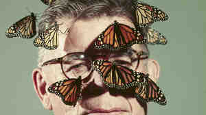 Butterfly breeder Carl Anderson with monarch butterflies on his face, 1954