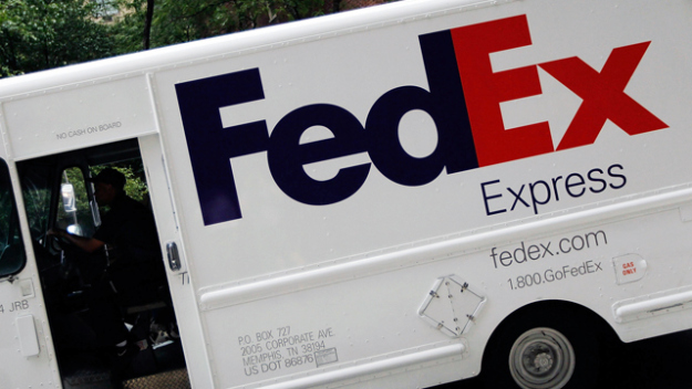 A FedEx truck is seen delivering a package. (credit: Chris Hondros/Getty Images)