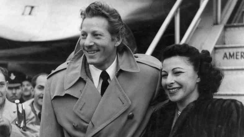 Danny Kaye arrives at London Airport with his wife, Sylvia Fine Kaye, in 1948.