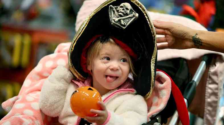 Candice Nelson fits her daughter Arya Kubesh with a Halloween hat at a store at Galleria Mall in Edina, Minn. Retailers are hoping Halloween will give them a good bounce into the peak spending time of the year.