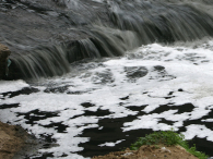 Wastewater creates white foam as it is discharged into a river. (credit: Getty Images/China Photos)