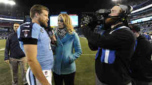 NFL sideline reporter Alex Flanagan (center) interviews Tennessee Titans quarterback Ryan Fitzpatrick last year.