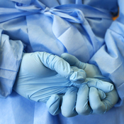 The gloved hands of an army nurse are seen during a demonstration of an isolation chamber for the treatment of infectious disease patients, at the Germany army medical centre, Bundeswehr Clinc, in Koblenz on Oct. 16, 2014.