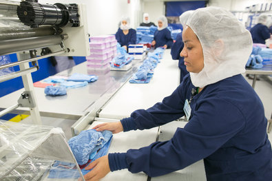 Workers assemble personal protection kits at a Medline plant in Illinois. Makers of protective equipment say demand has spiked, as hospitals brace for potential Ebola cases.