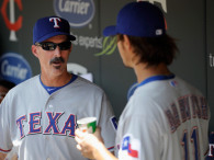 MINNEAPOLIS, MN - APRIL 14: Mike Maddux #31 of the Texas Rangers speaks with Yu Darvish #11 in the dugout during the sixth inning on April 14, 2012 at Target Field in Minneapolis, Minnesota. (Photo by Hannah Foslien/Getty Images)