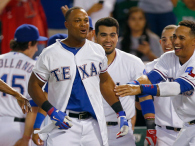 Adrian Beltre of the Texas Rangers celebrates with his team after hitting the game winning walk-off home run against the Oakland Athletics in the bottom of the ninth inning at Globe Life Park in Arlington on September 25, 2014 in Arlington, Texas. (credit: Tom Pennington/Getty Images)
