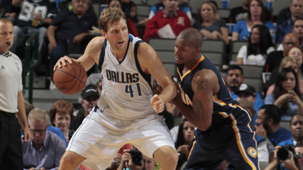 Dirk Nowitzki of the Dallas Mavericks posts up against David West of the Indiana Pacers on October 12, 2014 at the American Airlines Center in Dallas, Texas. (credit: Danny Bollinger/NBAE via Getty Images)