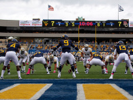 Clint Trickett #9 of the West Virginia Mountaineers directs the offense in the first half against the Baylor Bears  during the game on October 18, 2014 at Mountaineer Field in Morgantown, West Virginia.  (Photo by Justin K. Aller/Getty Images)