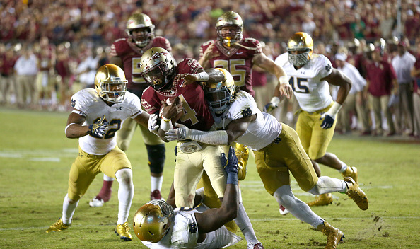 TALLAHASSEE, FL - OCTOBER 18: Jaylon Smith #9 of the Notre Dame Fighting Irish hits Dalvin Cook #4 of the Florida State Seminoles during their game at Doak Campbell Stadium on October 18, 2014 in Tallahassee, Florida. (Photo by Streeter Lecka/Getty Images)