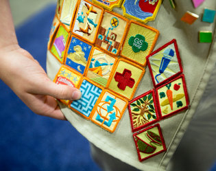 Girl Scout badges now include digital filmmaking, financial literacy and eating local.