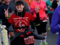 Emily Desmet, 27 of Ann Arbor shows her excitement as she crosses over the Ambassador Bridge on the American side at the third mile mark during the 37th Annual Detroit Free Press/Talmer Bank Marathon in Detroit on Sunday, Oct. 19, 2014.
Desmet who was running the half marathon finished with a time of 2:29:45.