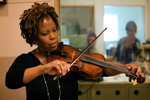 Violinist Regina Carter warms up in the On Point studio on Friday, October 17. (Robin Lubbock / WBUR)