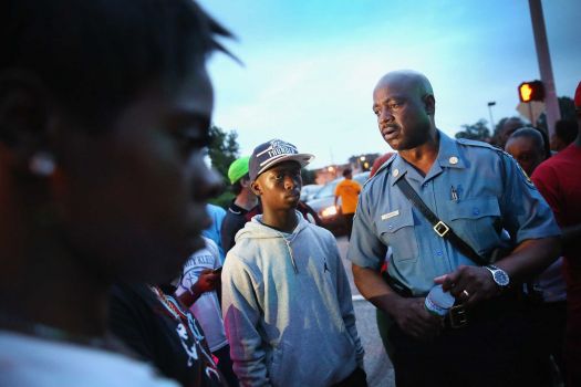 FERGUSON, MO - AUGUST 16:  Capt. Ronald Johnson (R) of the Missouri State Highway Patrol, who was appointed by the governor to take control of security operations in the city of Ferguson, greets demonstrators on August 16, 2014 in Ferguson, Missouri. Violent protests have erupted nearly every night in the city since the shooting death of teenager Michael Brown by a Ferguson police officer on August 9.  (Photo by Scott Olson/Getty Images) Photo: Scott Olson, Staff / 2014 Getty Images