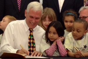 Gov. Mike Pence signs legislation creating a state-funded preschool pilot program.