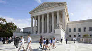 The Supreme Court early Saturday declined to block a Texas Voter ID law for the November election.