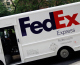 A FedEx truck is seen delivering a package. (credit: Chris Hondros/Getty Images)
