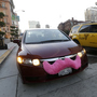 A Lyft driver in San Francisco drops off a passenger as a taxi passes by. The smartphone app lets city dwellers hitch rides from strangers.