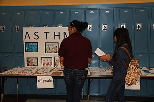 image of two girls standing in front of lockers at a display table