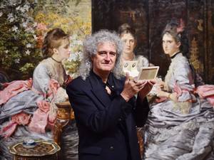 20 October 2014: British musician Brian May poses with an owl viewer in front of John Everett Millais painting 'Hearts are Trumps' in 1872 which was inspired by Michael Burr stereoscopic photograph also entitled 'Hearts are Trumps' 1866 as part of an exhibition entitled 'Poor man's picture gallery' : Victorian Art and Stereoscopic Photography at the Tate Britain in central London