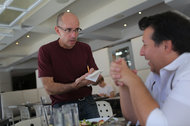 Mr. Zimmerman, left, mimicking the service by his friend Danny Cohen, a waiter at Cafeteria, a restaurant in Chelsea.