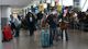 People wear masks at JFK Terminal 4 for international