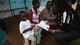 Ebola survivor Abrahim Quota, 5, is handed a letter