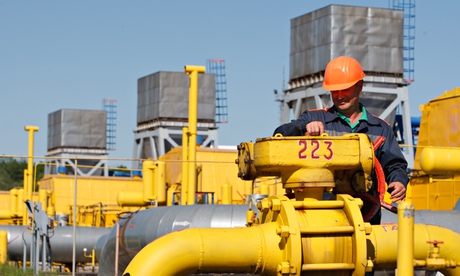 An employee tightens the valve on a pipe