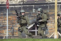  A Royal Canadian Mounted Police intervention team responds to a reported shooting at the Parliament building in Ottawa today. 