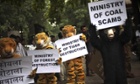 Greenpeace activists dressed as wild animals hold placards during a protest outside the office of the Indian coal minister