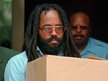 In this July 12, 1995 file photo, convicted police killer and death-row activist Mumia Abu-Jamal leaves Philadelphia´s City Hall after a hearing. A day after Abu-Jamal addressed graduates of a Vermont college, a House committee advanced a bill to give the family of the police officer he was convicted of killing a way to shut him up. (AP Photo/Chris Gardner, File)