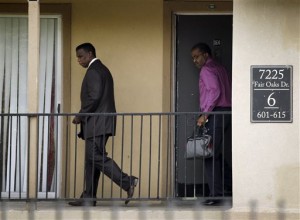 two Dallas county health officials outside Dallas apartment where Ebola patient lived