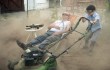 Bill Murray relaxes while Jaeden Lieberher mows his lawn in St. Vincent.