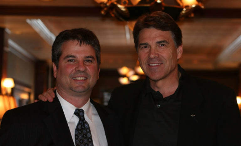 Gov. Rick Perry and GOP House candidate Charles Perry pose for photos in 2010.