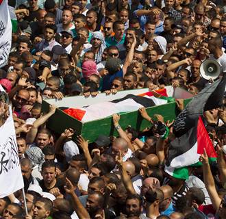 Image: Palestinians carry the body of 16-year-old teen Muhammed Abu Khdair during his funeral